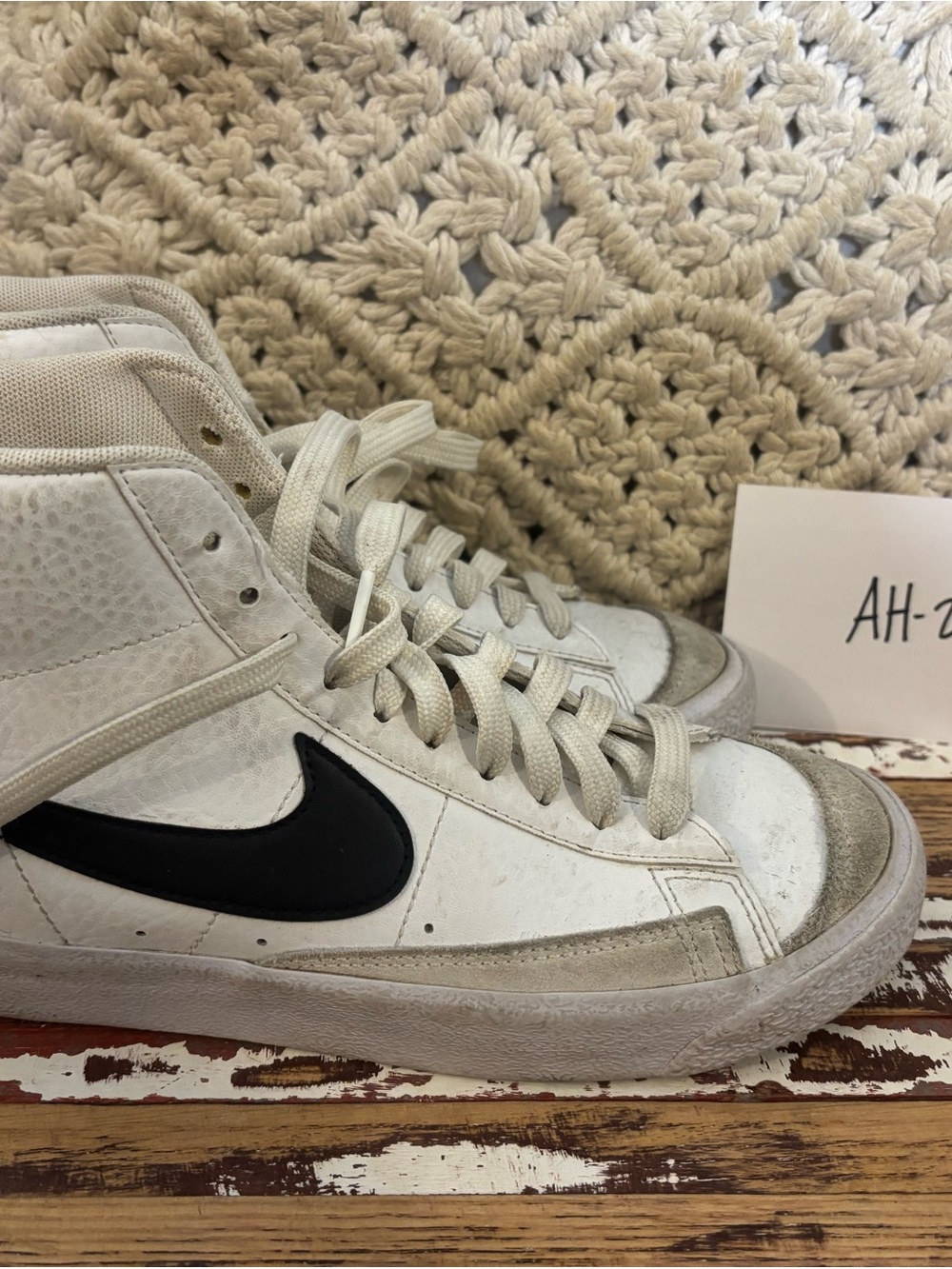 Nike White High-Top Sneakers with Black Swoosh